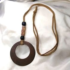 Handmade Wooden Circle Necklace. Brand New. Leather Strap Holds Beautiful Wooden Bold Circle. Kjj1028 Wooden Necklaces, Artisan Necklaces With Round Wooden Beads, Brown Necklace With Round Wooden Beads, Brown Wooden Necklace With Large Beads, Brown Wooden Beads Round Jewelry, Round Brown Wooden Jewelry, Leather Cord Jewelry, Cord Jewelry, Wooden Necklace