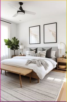 a bed sitting in a bedroom next to two framed pictures on the wall above it