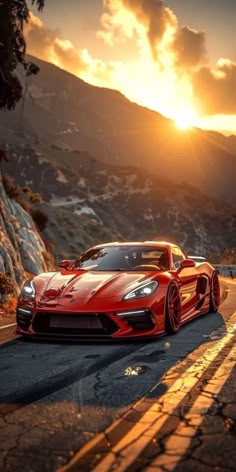 a red sports car driving down the road at sunset or sunrise with mountains in the background