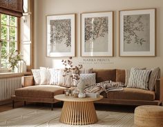 a living room filled with furniture and pictures hanging on the wall above a coffee table