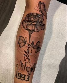 a woman's arm with flowers and butterflies on it, the words are written in black