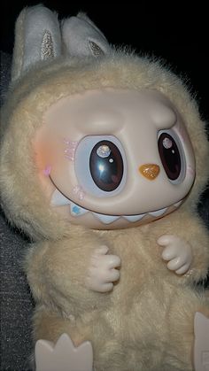 a close up of a stuffed animal with big eyes