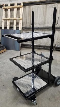 three tiered metal cart with wheels on the floor