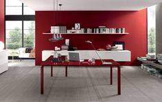 a red and white living room with modern furniture in the corner, along with bookshelves