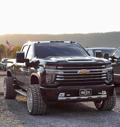 a large black truck parked in a parking lot