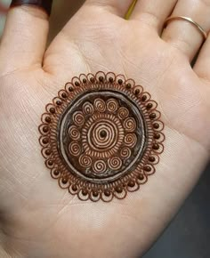 a woman's hand holding a henna tattoo