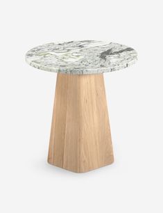 a white marble table with wooden base