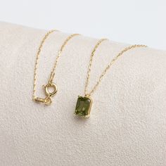 "Peridot; It is a stone of strength and balance. With its shimmering pale green color, peridot stone is also known as the \"evening emerald\". It is a gemstone often associated with spirituality and expression. Our rectangular peridot necklace, with its minimalist design, is a jewel that you can use daily and on special occasions. It is a nice gift for yourself and your loved ones. The birthstone of those born in August is peridot. 🔸🔸 Our elegant, style and stylish products suitable for specia Green Gemstone Birthstone Necklace In 14k Gold, Elegant Green Peridot Birthstone Necklace, Elegant Light Green Necklace For Gift, Peridot Birthstone Necklace For May, Yellow Gold Peridot Necklace Gift, Green 14k Gold Necklace For Gift, Green Birthstone Pendant Necklace In 14k Gold, Green Pendant Birthstone Necklace In 14k Gold, 14k Gold Green Birthstone Pendant Necklace