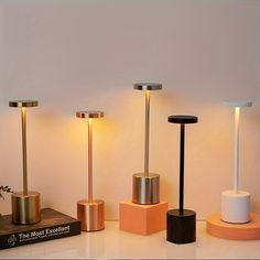 four different types of lamps on display in a room with white walls and flooring