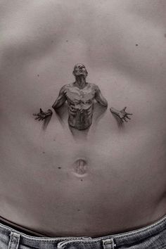 a man's stomach with an image of a demon on it