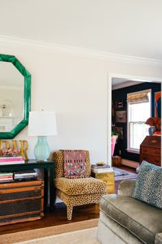 a living room filled with furniture and a mirror