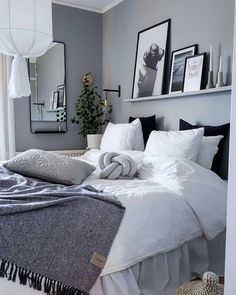 a bed with white sheets and pillows in a room