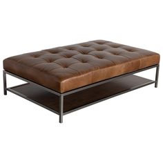 a brown leather ottoman sitting on top of a metal shelf