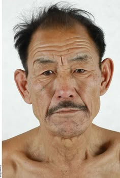 an old man with no shirt on posing for the camera