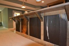 an empty living room with wood slats on the wall