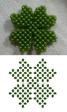 green beads are arranged in the shape of an eight - leafed clover on a white background