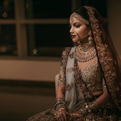 a woman in a bridal outfit sitting down