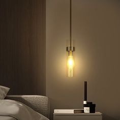 a lamp that is on top of a nightstand next to a bed in a room