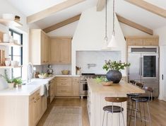 the instagram page shows an image of a kitchen with wooden cabinets and white walls