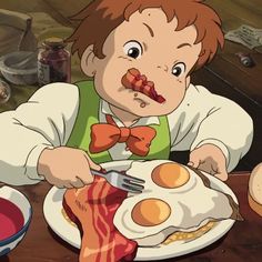 a young boy eating breakfast with bacon and eggs