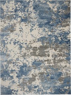 an abstract rug with blue and grey colors on it, including the area rug in the middle