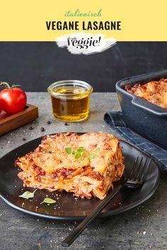 lasagna casserole on a black plate with a fork next to it