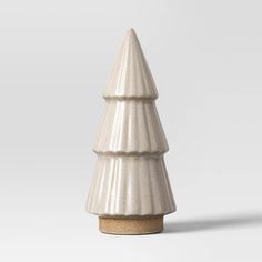 a white ceramic christmas tree on a grey background