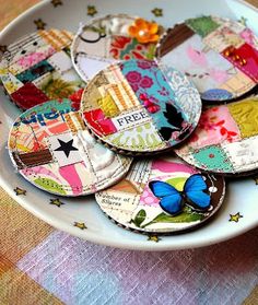 a white bowl filled with lots of different colored patchwork designs on top of a table