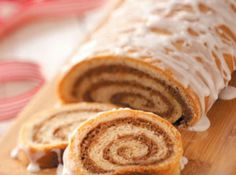 rolled up pastry sitting on top of a wooden table