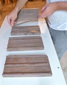 a man is making wooden planks out of plywood