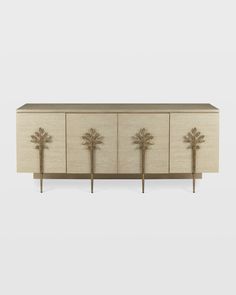 the sideboard is made out of wood and has three brass leaves on each side