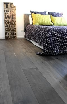 a bed sitting on top of a hard wood floor