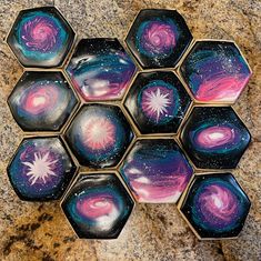 six hexagons painted with different colors and shapes in the shape of stars