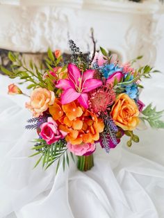 a bouquet of flowers is sitting on a bed