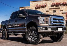 a black truck parked in front of a building