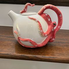 an octopus shaped tea pot sitting on top of a wooden table