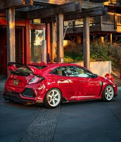 a red car parked in front of a building