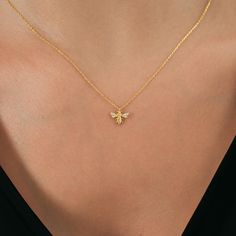 This beautiful 14K gold bee necklace is the ideal piece for nature enthusiasts and bee lovers. Featuring a delicate bumble bee pendant, this elegant piece of insect jewelry makes a thoughtful Christmas gift for your mother.  ✨ PRODUCT DETAILS ✨ * Material: 14K Solid Gold * Necklace Length: 18 Inches * Adjustable extension chain (16'' to 18'') * Closure: Spring ring * Chain style: Cable ✨ ABOUT US ✨ Welcome to Mezore Jewelry, where we specialize in creating unique and beautiful jewelry pieces. Our pieces are handcrafted with care using high-quality materials, making it the perfect addition to any outfit. ✨ CARE INSTRUCTIONS: ✨ To keep your necklace looking its best, we recommend avoiding exposure to water, perfumes, and other chemicals. We also recommend storing your necklace in a dry, cool Bumble Bee Necklace, Schmuck Gold, Bee Lover Gifts, Bee Jewelry, Mother Christmas Gifts, Insect Jewelry, Ring Chain, Bee Pendant, Gold Bee