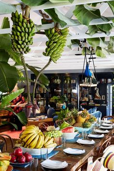 a dining room filled with lots of fruit and greenery