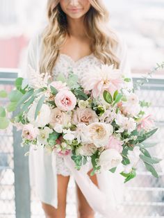 a woman holding a bouquet of flowers in her hands