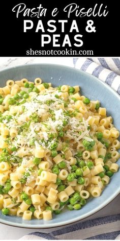 pasta with peas and parmesan cheese in a blue bowl on a striped cloth