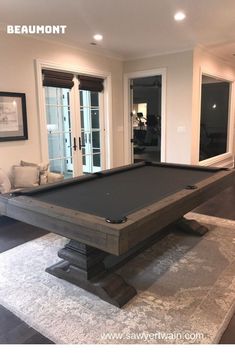 a pool table in the middle of a living room