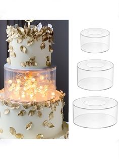 three tiered wedding cake with gold leaves on top and four clear plates below it