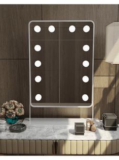 a vanity with several lights on it in front of a wall mounted mirror and vase