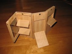 an open wooden box sitting on top of a hard wood floor