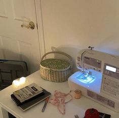 a sewing machine sitting on top of a white table