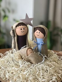 a nativity scene made out of burlock and twine with two dolls