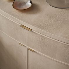 a close up of a dresser with a bowl on top