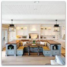 a large kitchen with an island in the middle and lots of counter space on one side