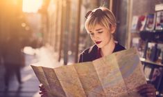 a woman looking at a map in the street